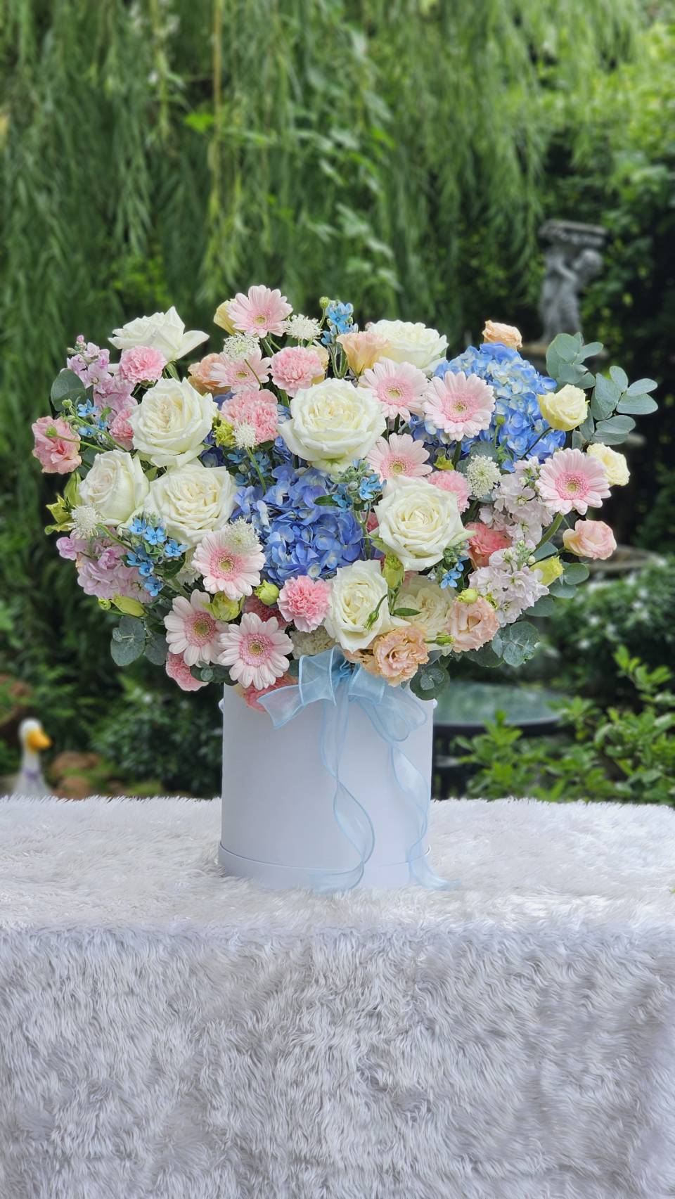 Inside ChorPhaka Florist, arranging a bouquet by hand